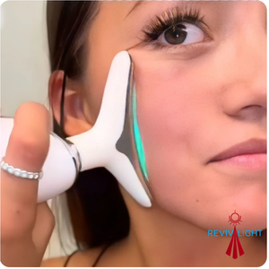 Woman using a device on her face with 'Reviv Light’ branding red light 